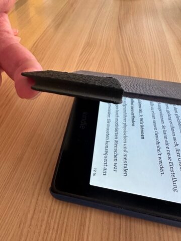 Finger hebt Hülle an mit Hilfe